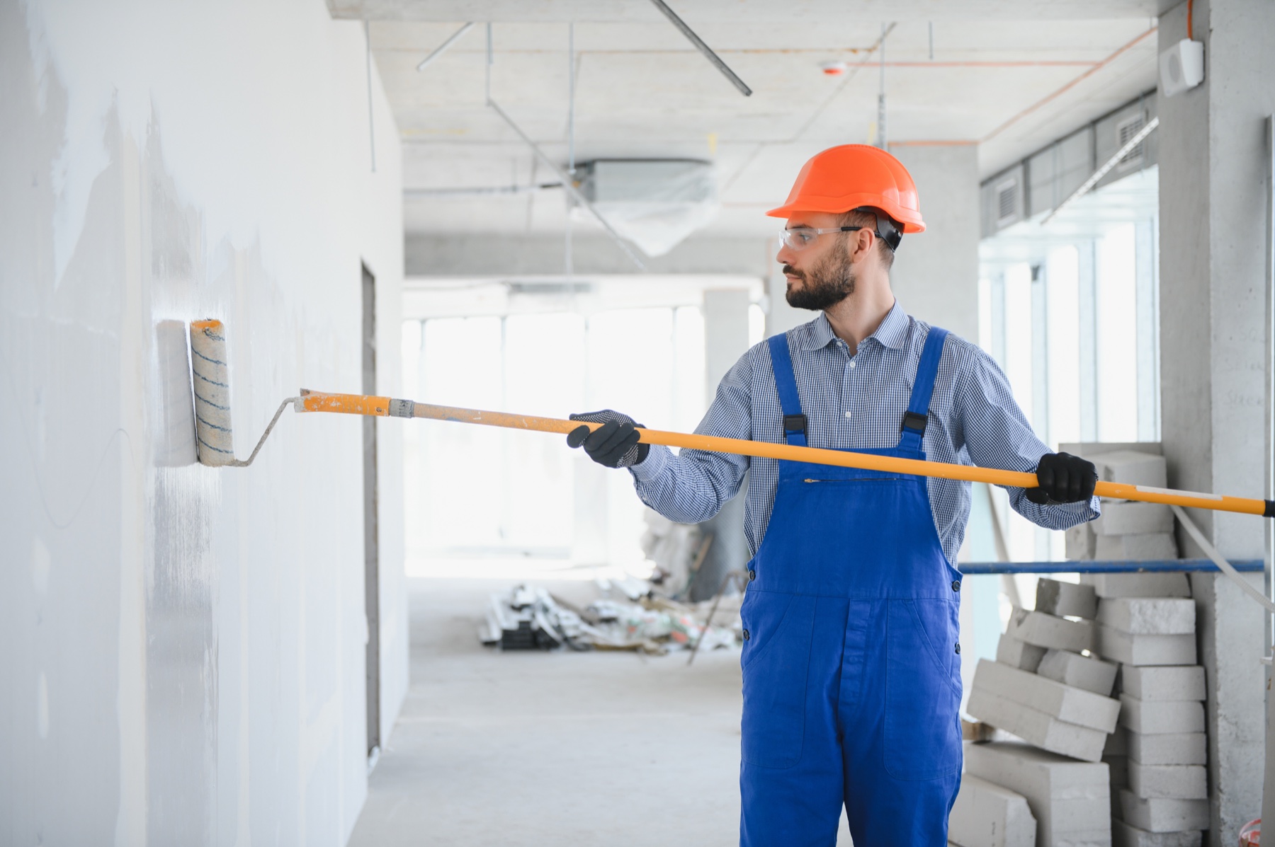 Professional painter applying paint with a roller
